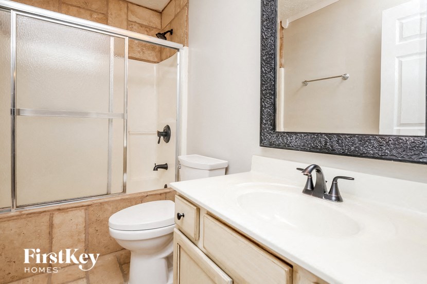 a bathroom with a sink toilet and a shower