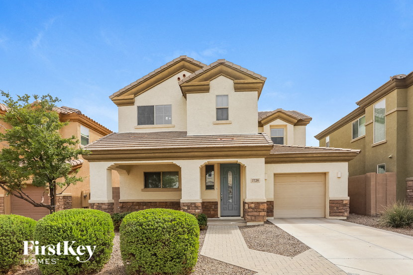 A house with a clear blue sky above it and the words "FirstKey Homes" on the bottom left.