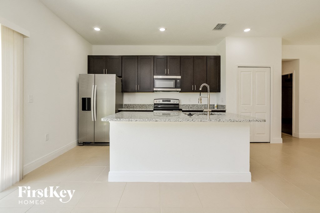 a kitchen with a counter top and a refrigerator