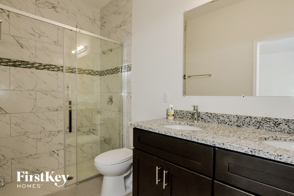 an image of a bathroom with a shower sink and toilet
