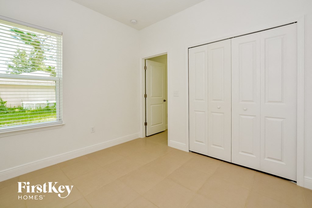 a bedroom with two closets and a door to a hallway