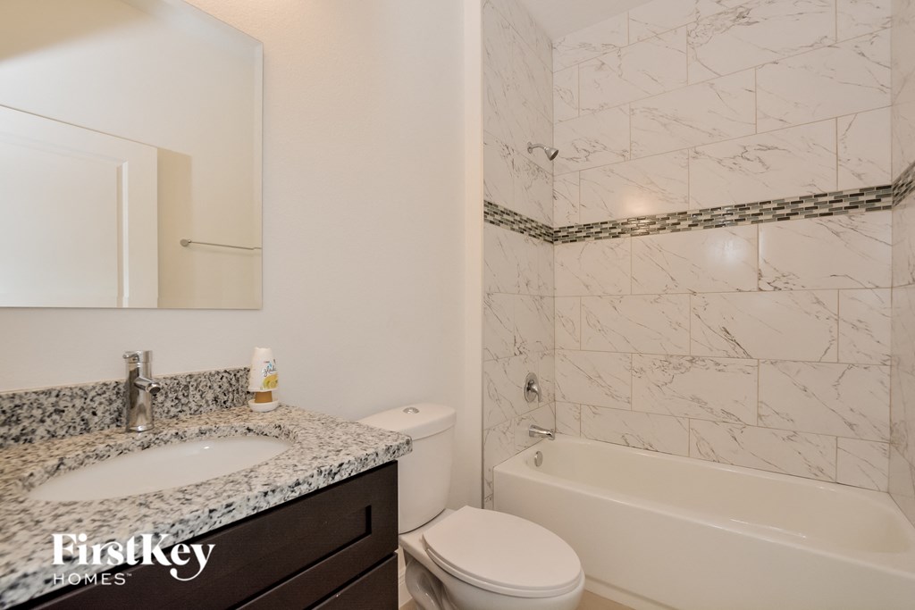 an image of a bathroom with a sink toilet and shower