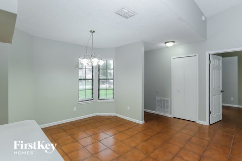 the living room and dining room with a door to the backyard