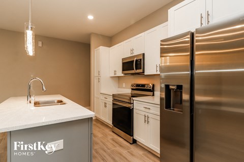 a kitchen with stainless steel appliances and white cabinets