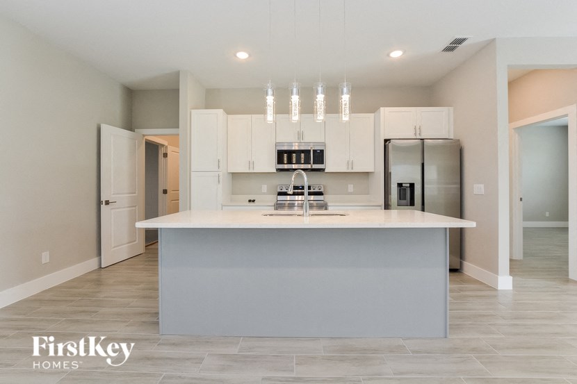 a kitchen with white cabinets and a white counter top