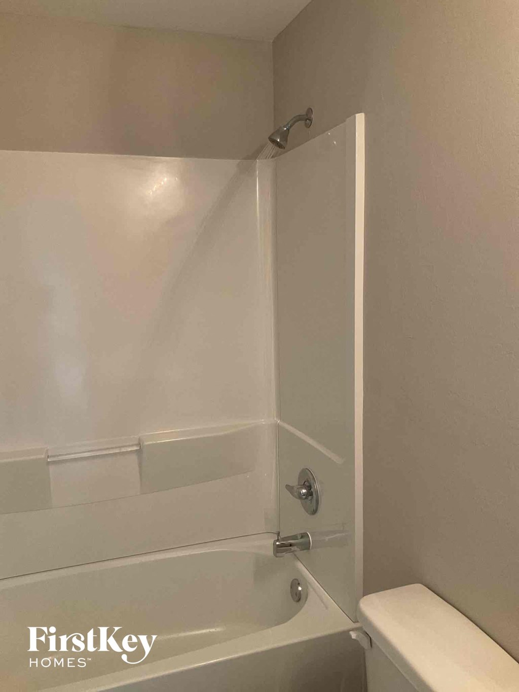 a white bathroom with a tub and a toilet