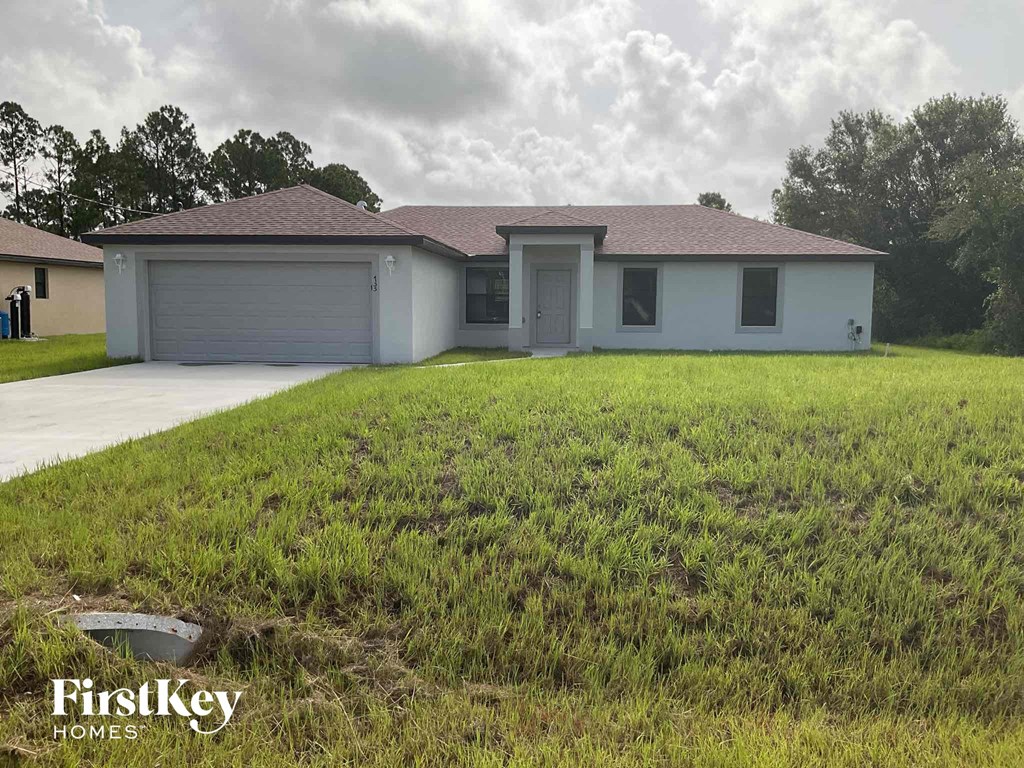 a house with a yard and a garage