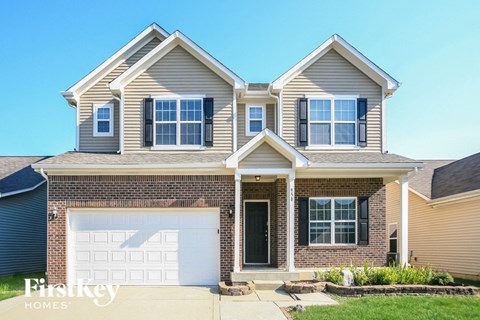 a brick house with a white garage door