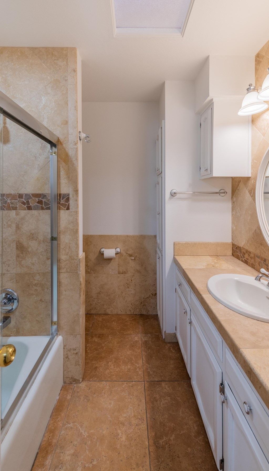 a bathroom with a shower and a sink and a mirror