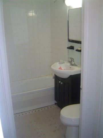 a bathroom with a toilet and a sink and a bath tub