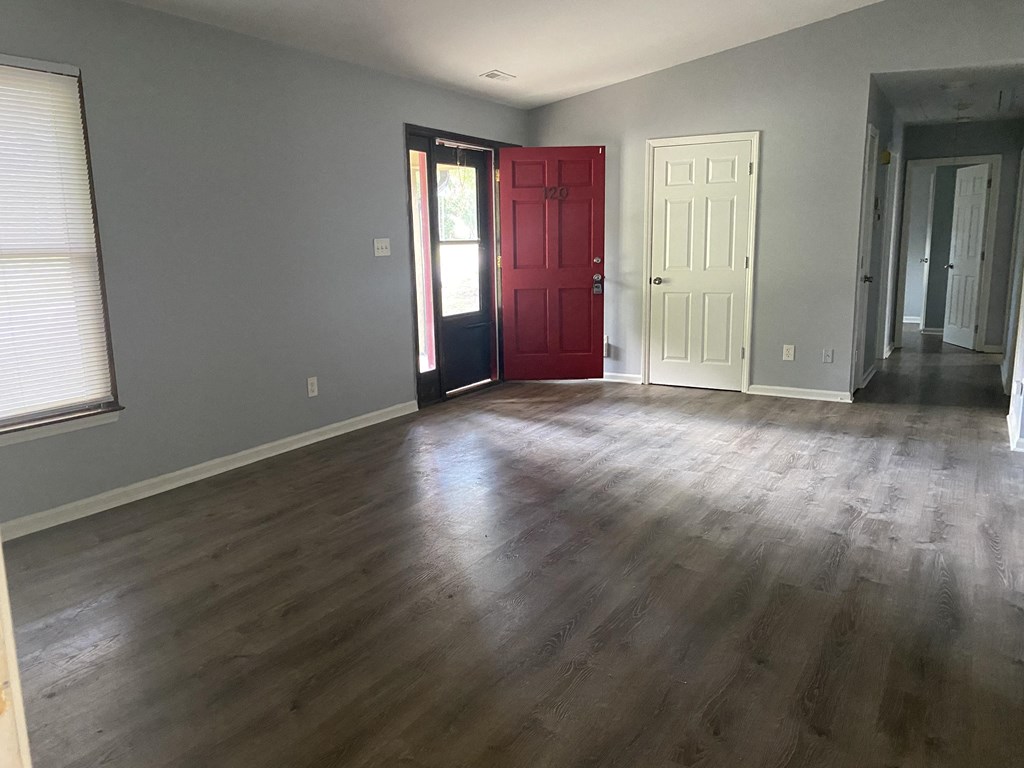 A room with a red door and a white door.