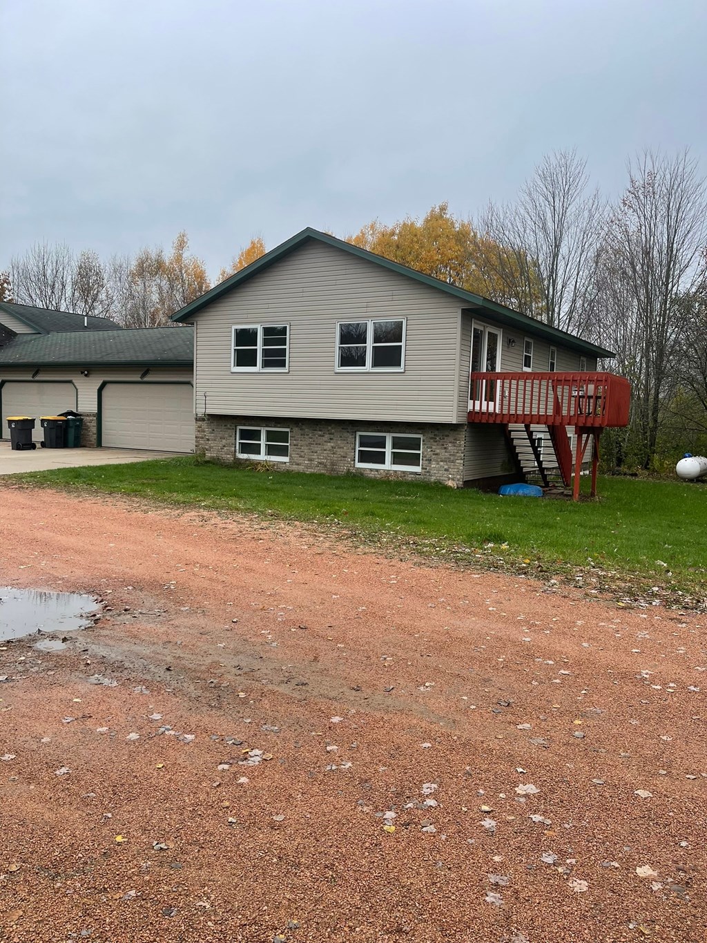 a house with a dirt road in front of it