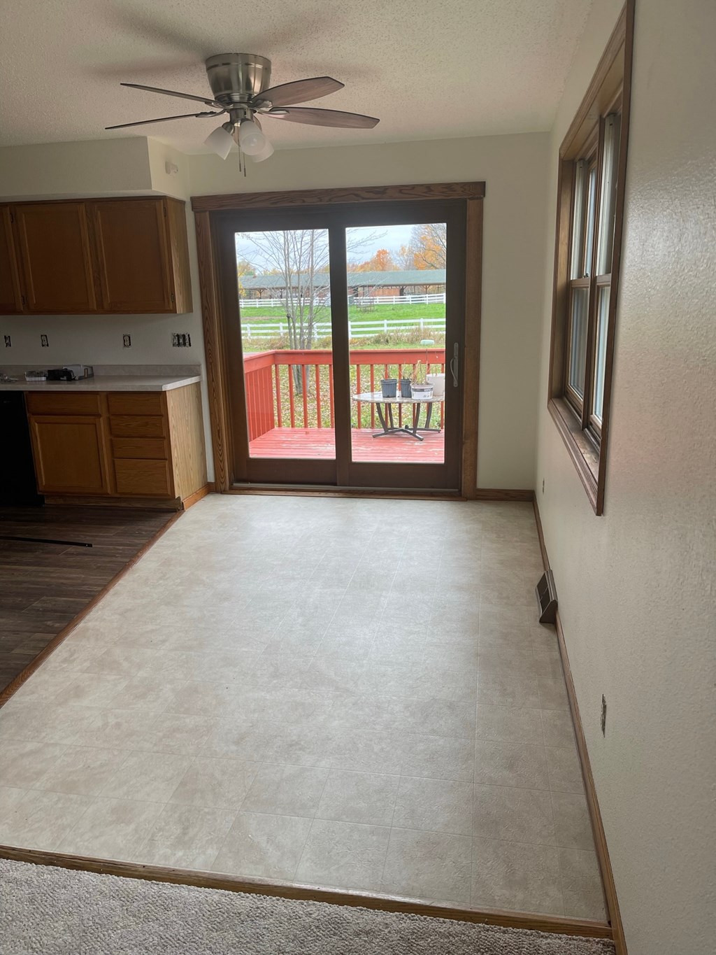an empty living room with a sliding glass door to a balcony