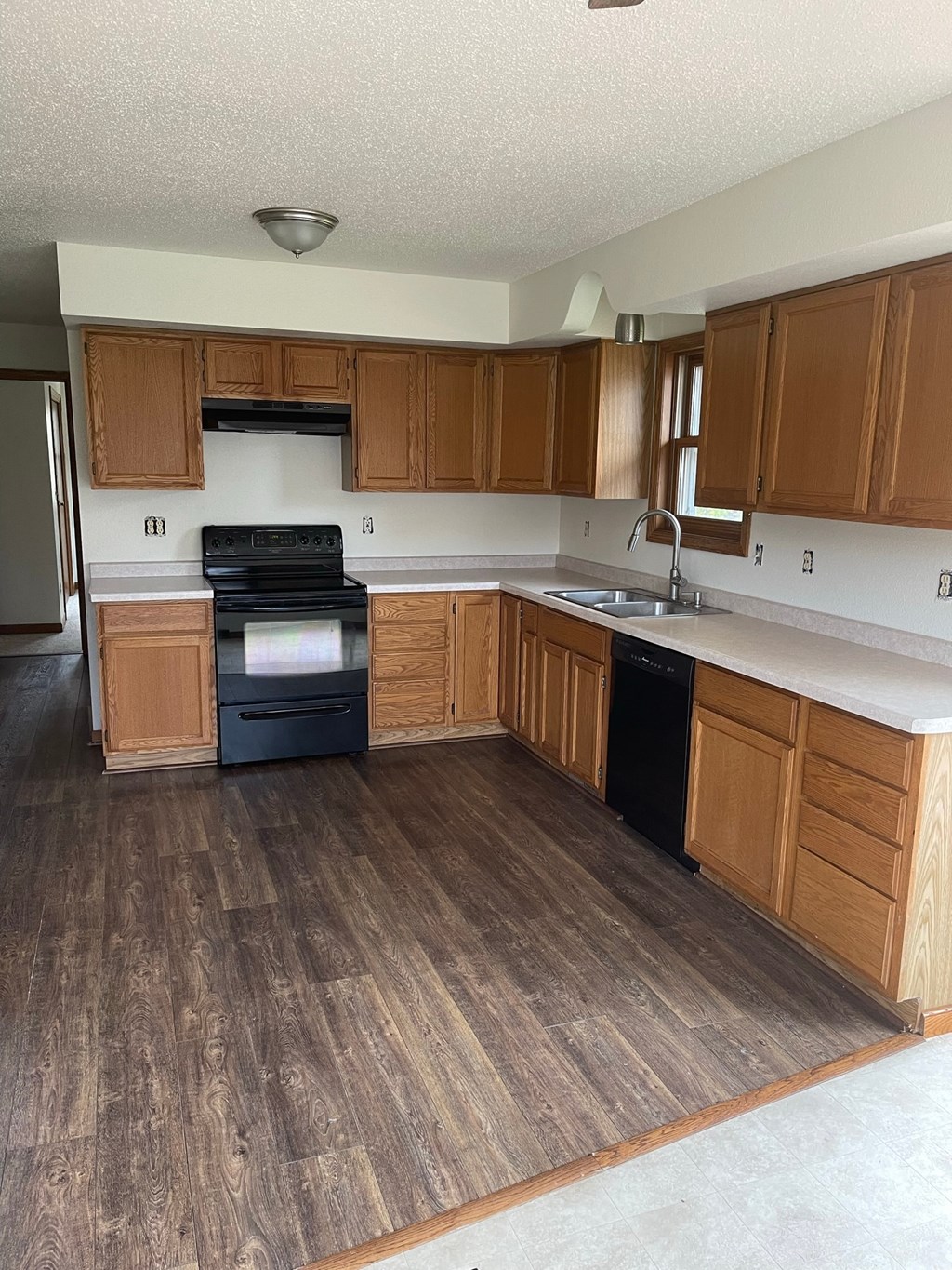 a kitchen with wooden cabinets and a stove and a sink