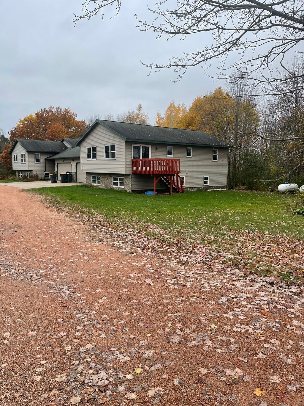 a house with a dirt road in front of it