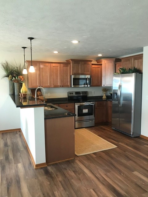 a kitchen with stainless steel appliances and wooden cabinets