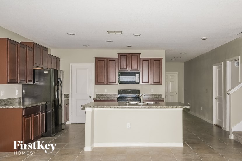 A kitchen with brown cabinets and a white island.