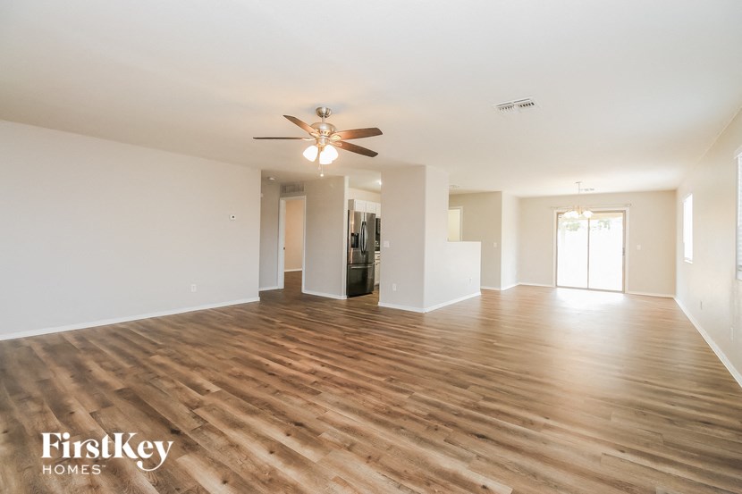 a living room with hardwood floors and a ceiling fan