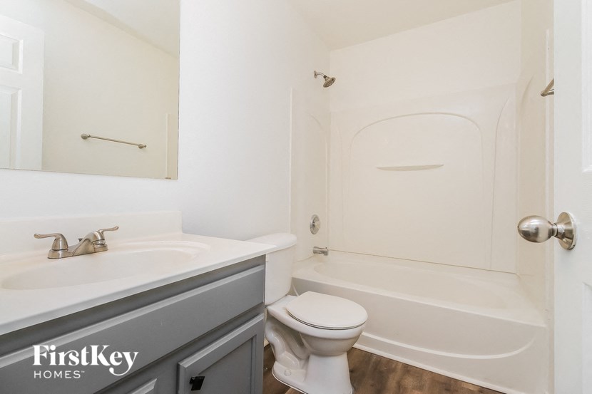 a bathroom with a sink toilet and a bath tub