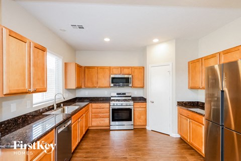 A kitchen with wooden cabinets and stainless steel appliances.