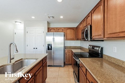 A kitchen with wooden cabinets and stainless steel appliances.