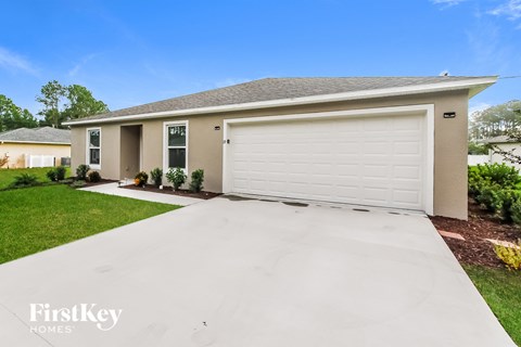a white driveway in front of a house with a white garage door