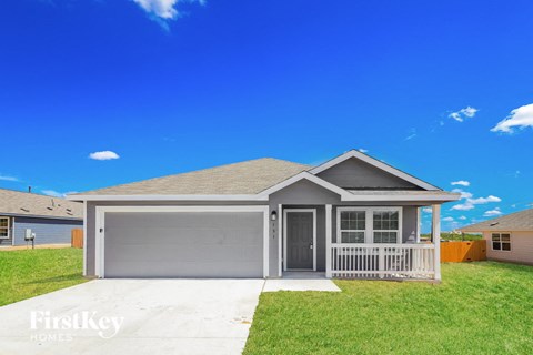 A house with a grey garage door is for sale.