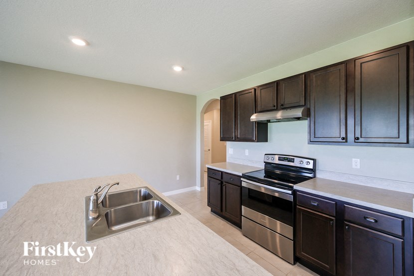 a kitchen with stainless steel appliances and black cabinets
