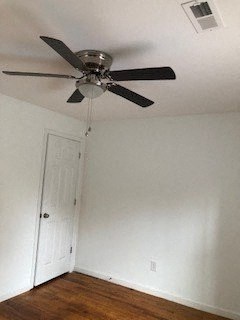a bedroom with a ceiling fan and a door