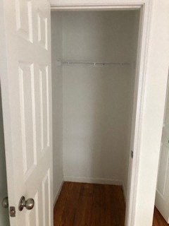a hallway with a white closet and a door
