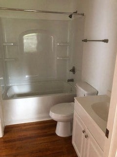 a bathroom with a toilet and a tub and a sink