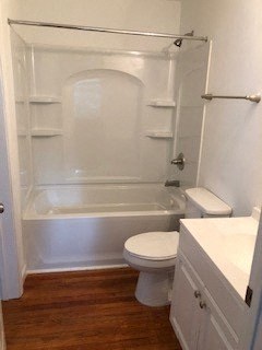 a white bathroom with a toilet and a bath tub