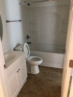 a bathroom with a toilet and a tub and a sink