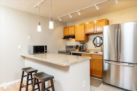 a kitchen with a counter top and a refrigerator