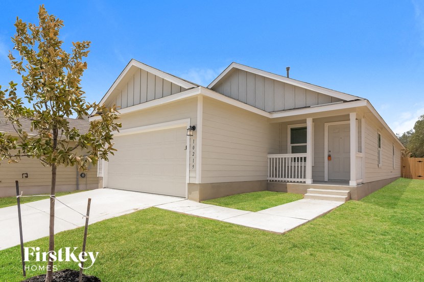 the exterior of a house with a lawn and a porch