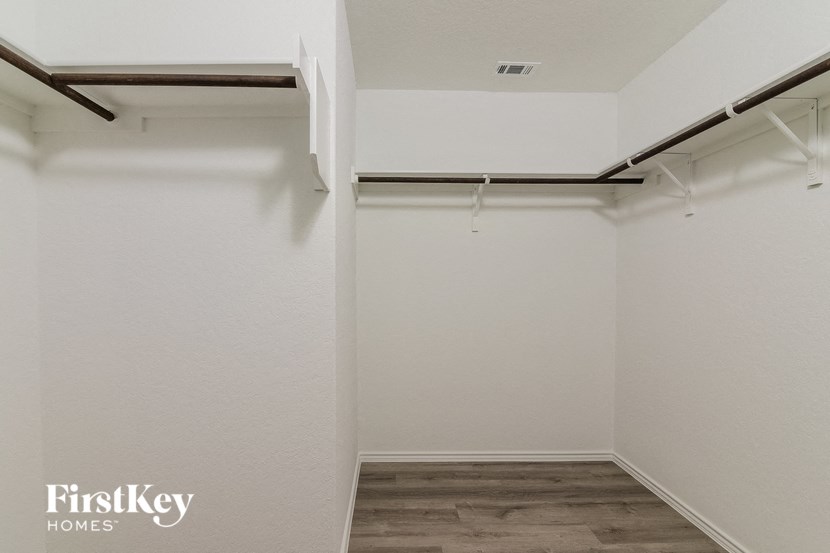 an empty room with white walls and a garage door