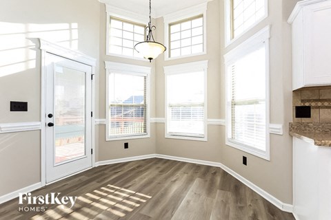 A sunny room with a view of the city through the windows.