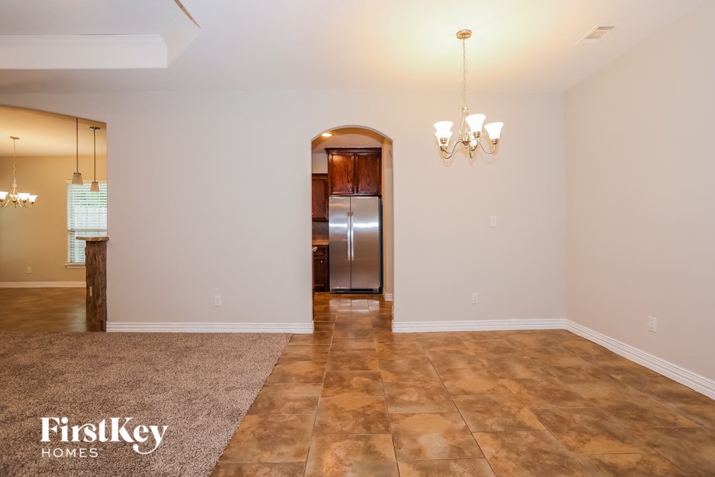 the living room and dining room with stainless steel appliances