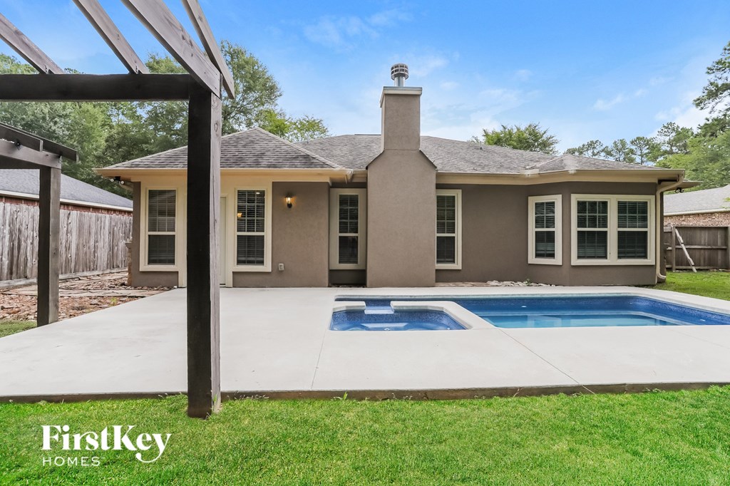a backyard with a pool and a house