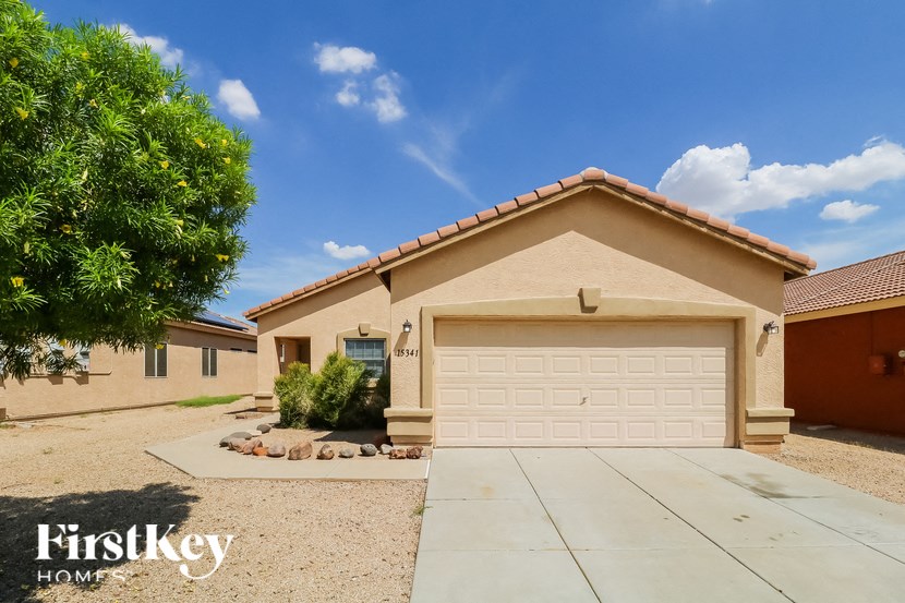A house with a garage door numbered 8345 is for sale.