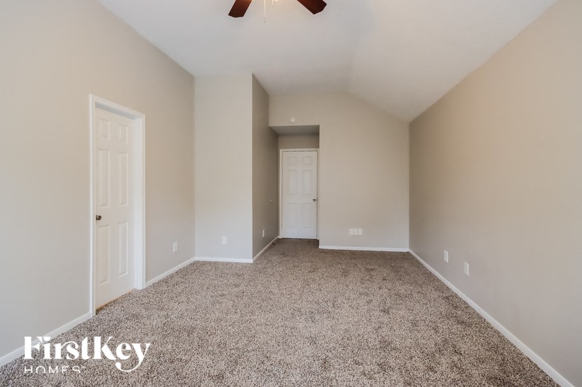 an empty room with carpet and a white door