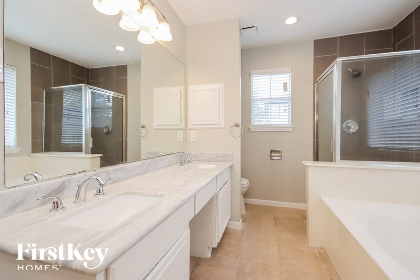 a large bathroom with two sinks and a large mirror