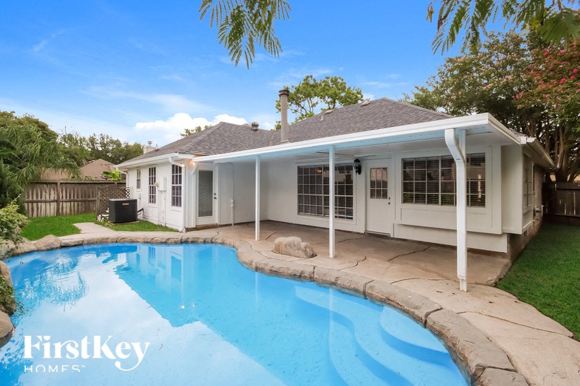 a house with a swimming pool in front of it