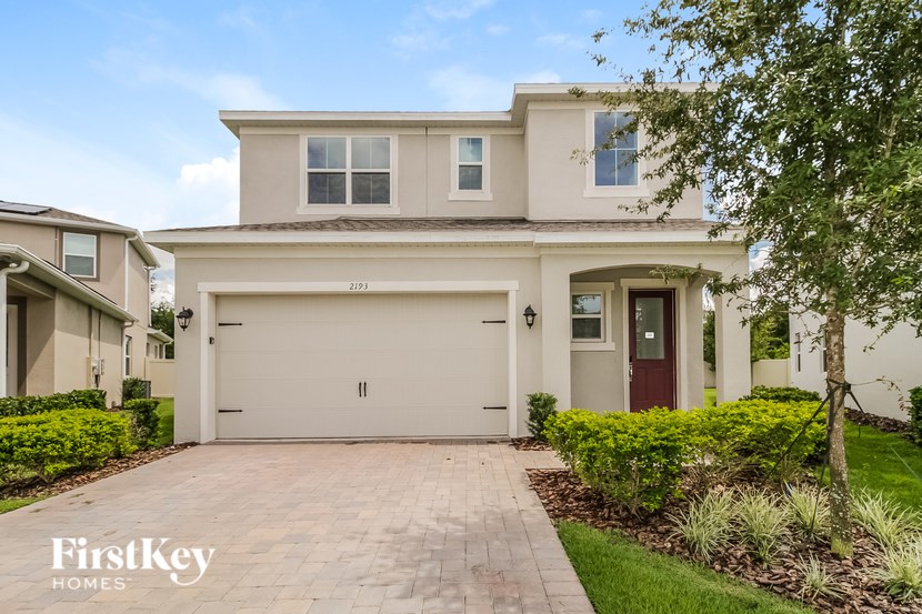 A two-story house with a garage is for sale.
