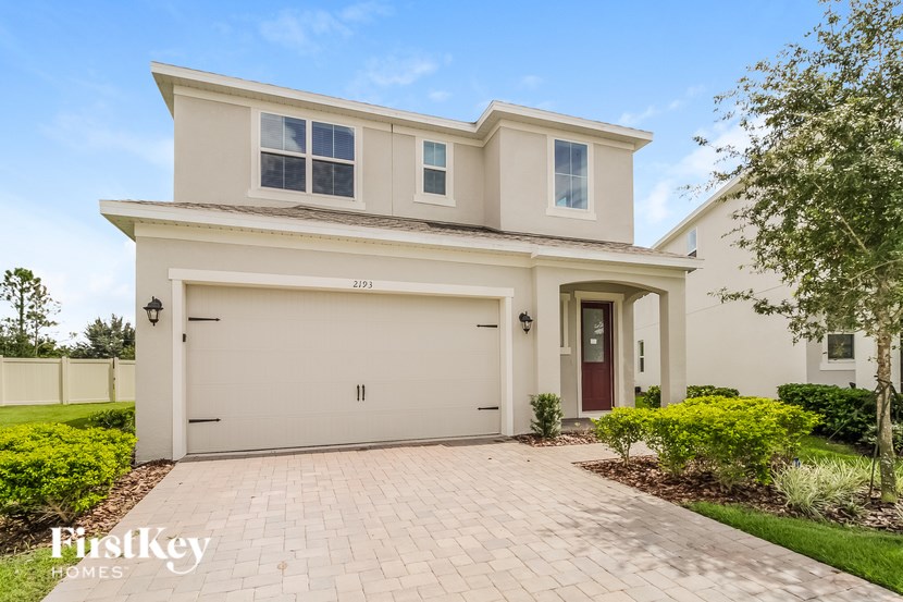 A two-story house with a garage is for sale.