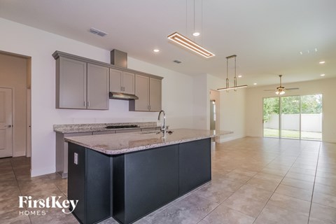 A kitchen with a marble countertop and a sink.