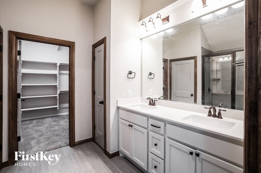 a bathroom with a white sink and a mirror