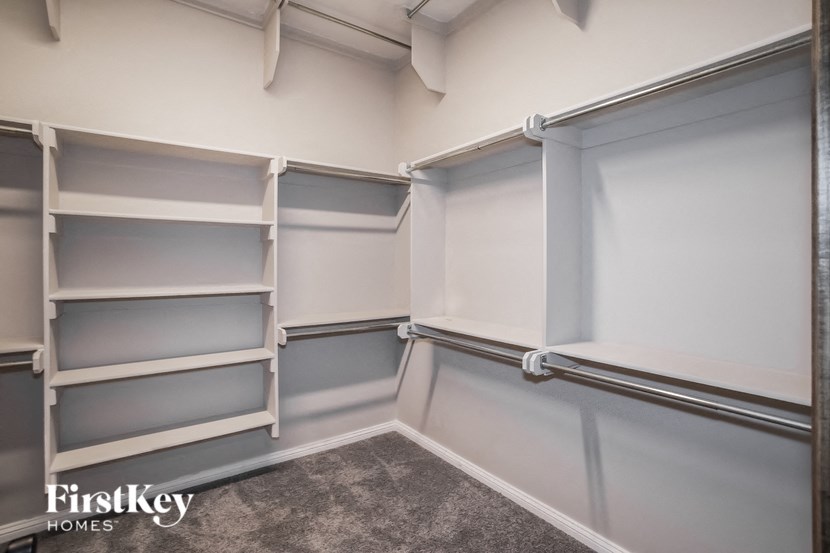 a walk in closet with frosted glass doors and shelves