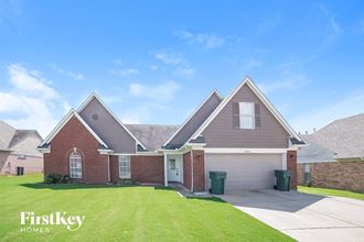 a house with a driveway and a lawn