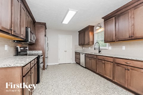 a kitchen with wooden cabinets and a counter top and a sink